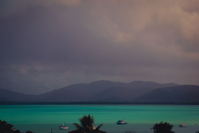 Scenic view of sea and mountains against sky