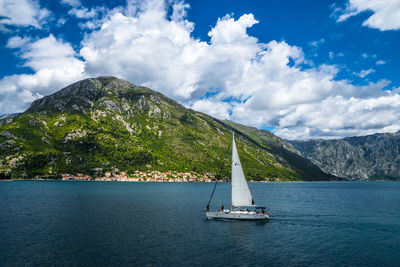 Sailboat in sea against sky