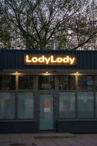 Information sign against trees at night