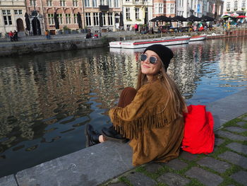 Young woman with sunglasses against canal