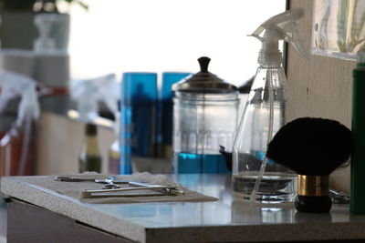 Close-up of barber shop bottles on table