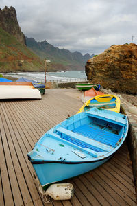 Boats moored at pier