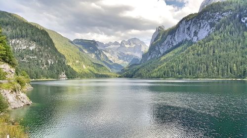 Scenic view of lake against cloudy sky