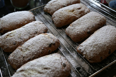 Close-up of pastry items with powdered sugar on baking sheet