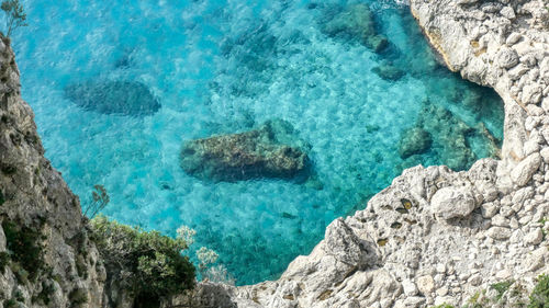 High angle view of rocks in sea