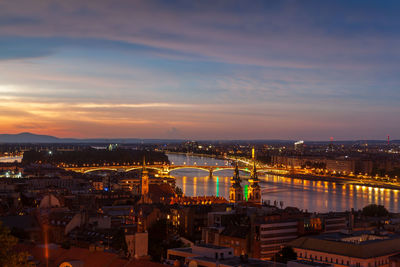 High angle view of city lit up at night