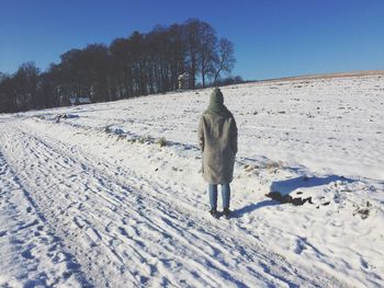 Person standing on snow covered field
