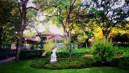 Statue by trees against sky