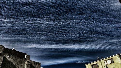 Low angle view of building against cloudy sky