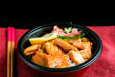 Close-up of food in plate against black background