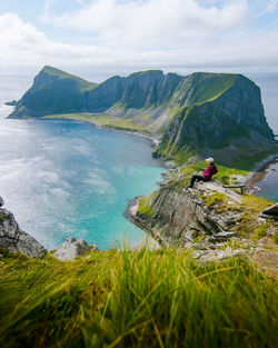 Scenic view of sea and mountains against sky