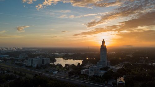 Aerial view of buildings in city during sunset