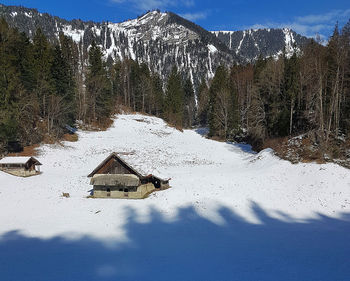 Snow covered land and mountains against sky