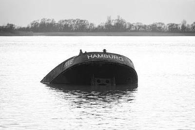 Boat in lake against sky