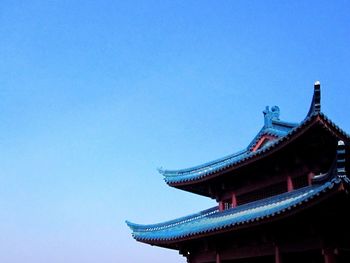 Low angle view of built structure against clear blue sky