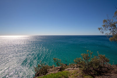 Scenic view of sea against clear blue sky