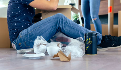 Low section of man sitting on table