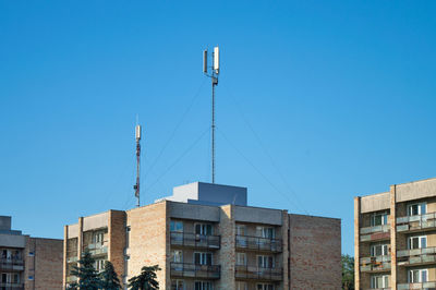 Low angle view of buildings against clear blue sky