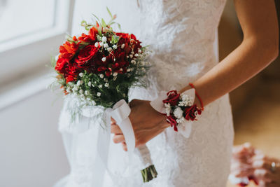 Midsection of woman holding flower bouquet