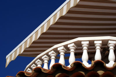 Low angle view of striped canopy over balcony