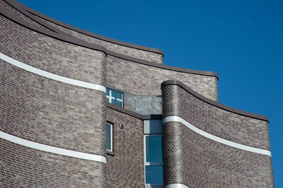 Low angle view of building against clear blue sky