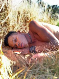 Portrait of woman lying down on land