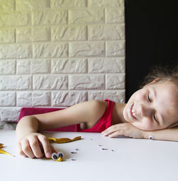 Portrait of young woman writing on book