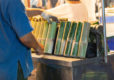Midsection of man holding books
