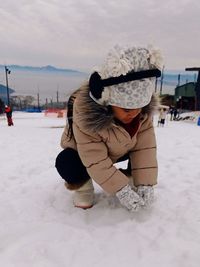 Rear view of woman on snow covered field