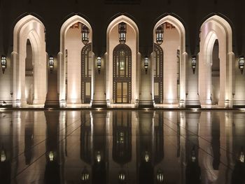 Reflection of illuminated building in water at night