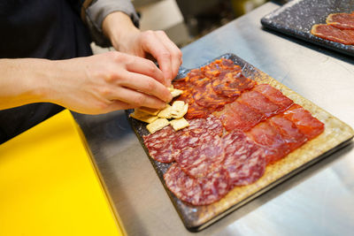 Midsection of man preparing food