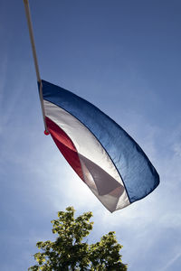 Low angle view of dutch flag against sky