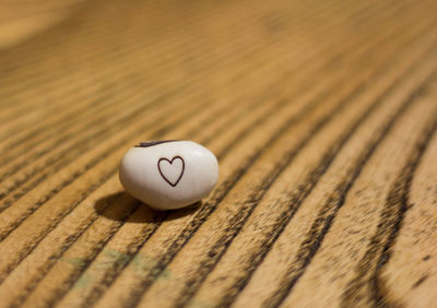 Close-up of heart shape on white pebble 