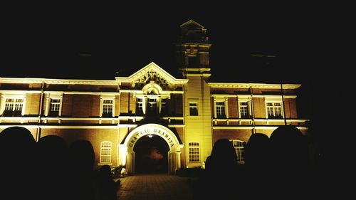 Illuminated building against sky at night