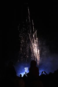 Group of people watching fire crackers at night