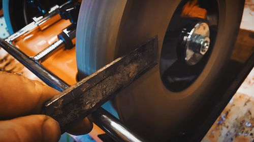 Close-up of man working in machine