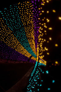 Low angle view of illuminated lights at night