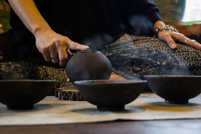 Midsection of person preparing food on table