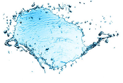 Close-up of water drops on glass against white background