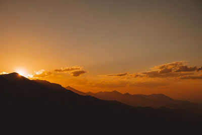 Scenic view of mountains against sky during sunset