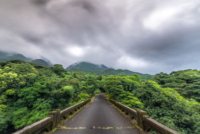 Scenic view of green mountains against sky