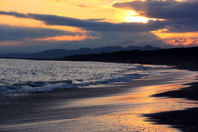 Scenic view of beach against sky during sunset