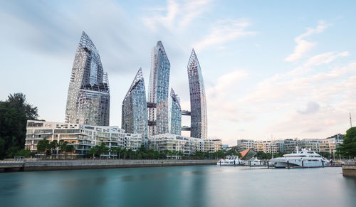 View of buildings in city against cloudy sky