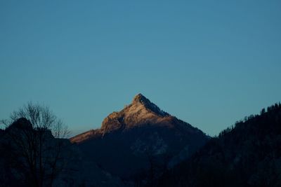 Low angle view of mountain against clear blue sky