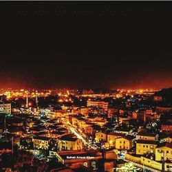 High angle view of illuminated buildings in city at night