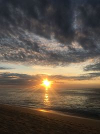 Scenic view of sea against sunset sky