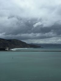Scenic view of mountains against cloudy sky