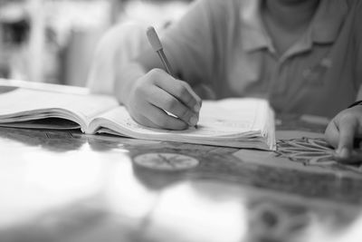 Close-up of man working by table