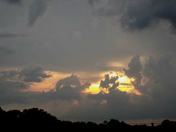Silhouette of landscape against cloudy sky