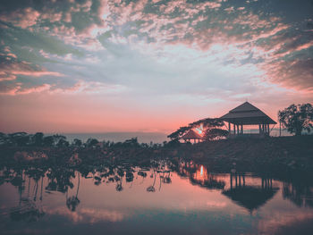 Scenic view of swimming pool against sky during sunset